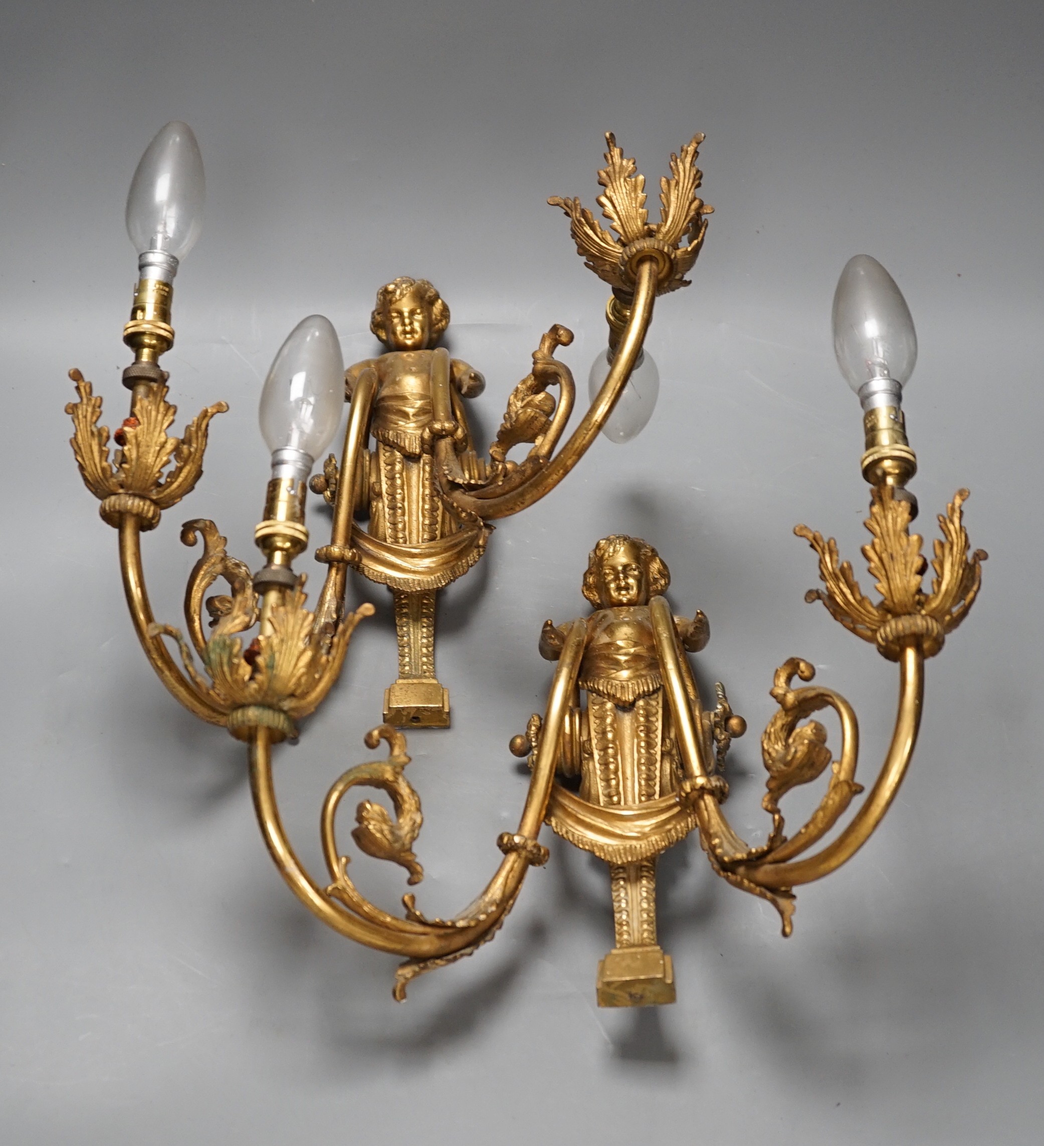 A pair of Louis XVI style ormolu figural twin branch wall lights, 30cm high